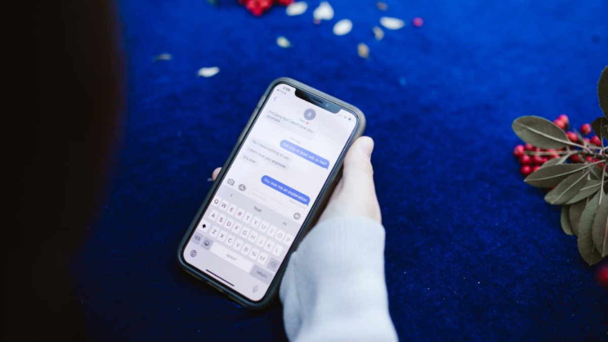 Person rereading a sent text message and overthinking its wording.